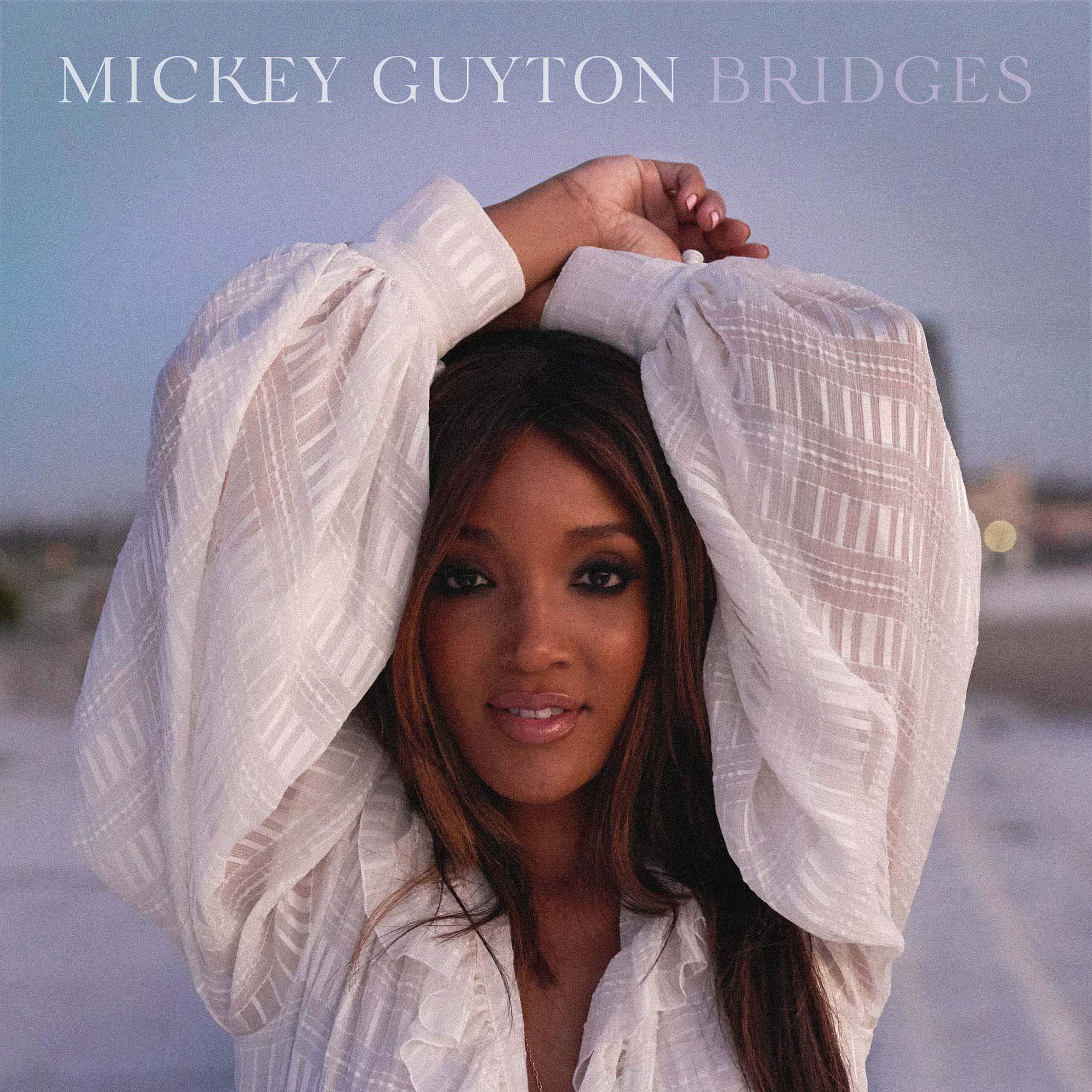 Mickey divides her time between Nashville and Los Angeles, where she happened to be during the pandemic. "I recorded my EP over Zoom," Mickey explains. "I'm right in downtown Los Angeles, and the protests were going on right outside of my apartment. They were peaceful from what I've seen, but I wrote 'Heaven Down Here' being cooped up and feeling like the world was burning down around me." Image: Phylicia J.L. Munn Mickey Guyton's "Bridges" EP cover