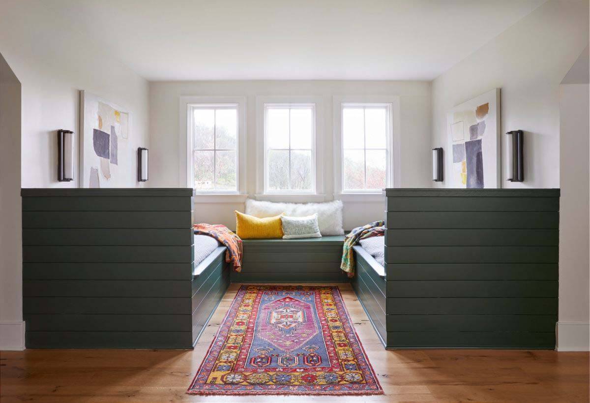 The second floor has a guest bedroom, the kids' bedrooms, a playroom and a study area, while the third floor features a sleeping nook designed for younger guests. Sara designed bunk-style beds to offer privacy for young sleepers without blocking the views and natural light. Next door, a playroom has a slide that carries you from the third-floor playroom to the second-floor playroom. Sleeping nook with bunk-style beds