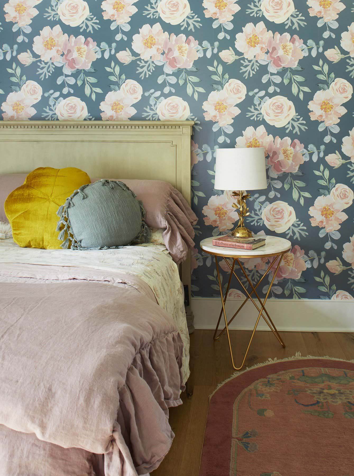 As someone who gravitates towards pinks and frills, the youngest daughter got a design more appropriate for her. Both sisters have one wallpapered wall that suits their style. Patterned wallpaper in bedroom