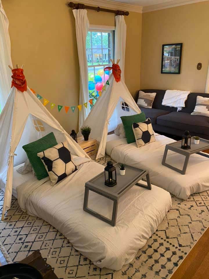 Two teepees set up and decorated for a young boy's birthday