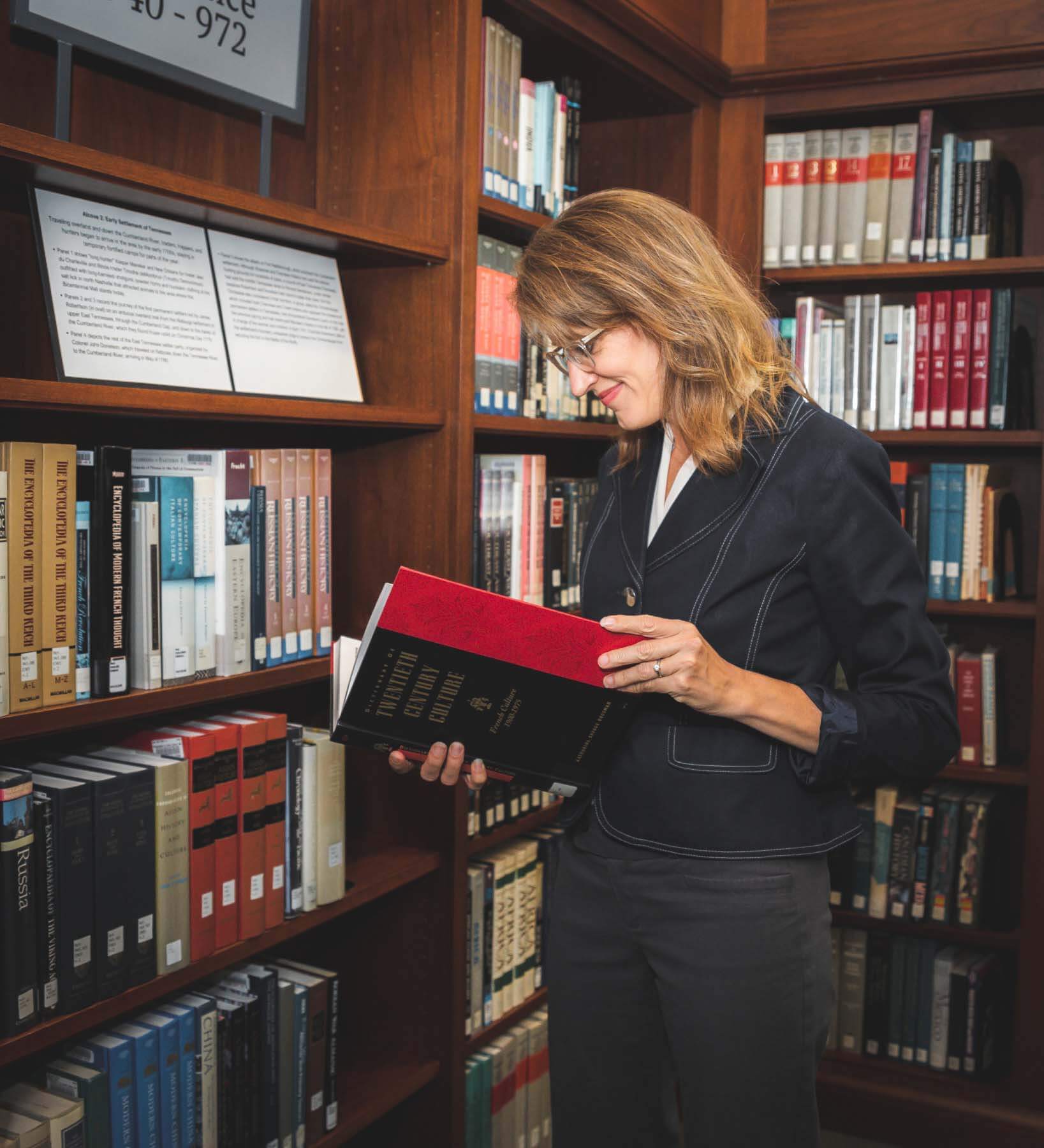 "Sometimes people think fundraising is just asking for money," Shawn explains, "but it’s really inviting people to share their story and passion and get involved." Shawn Bakker, reading in the library