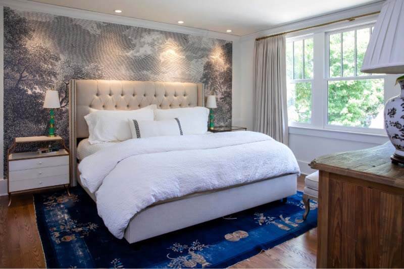 Master bedroom with black and white mural behind bed at Cherokee Park home