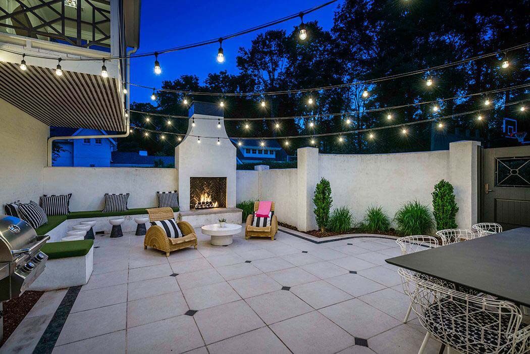 Backyard living space with lights by Page Duke