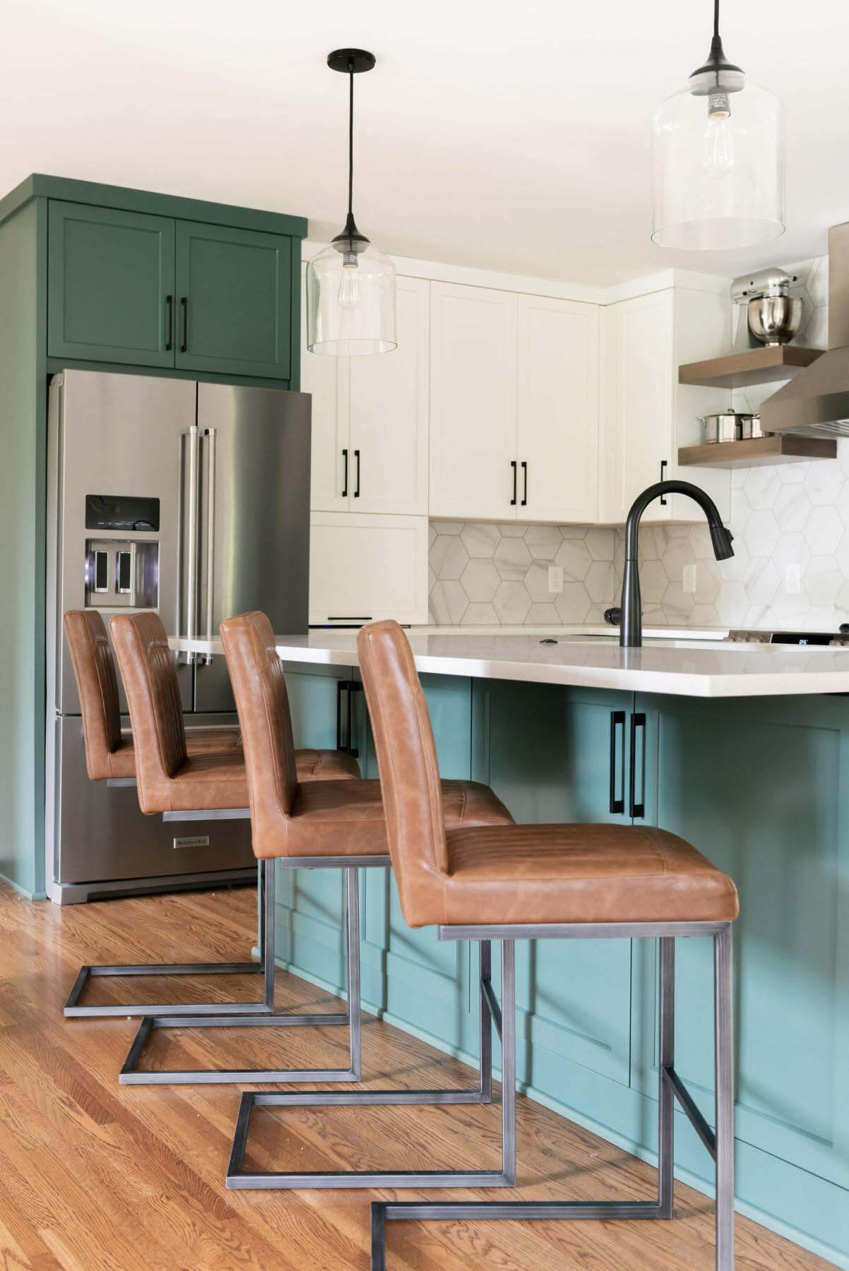 The kitchen after the renovation features four barstools at the island counter
