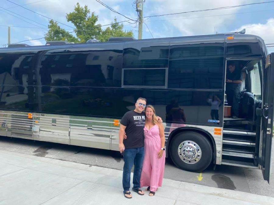 Greg and Tracie pose in front of tour bus in Nashville