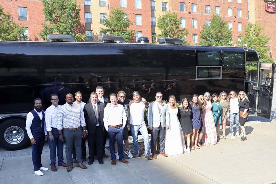 Tour bus and wedding crew for a wedding on wheels