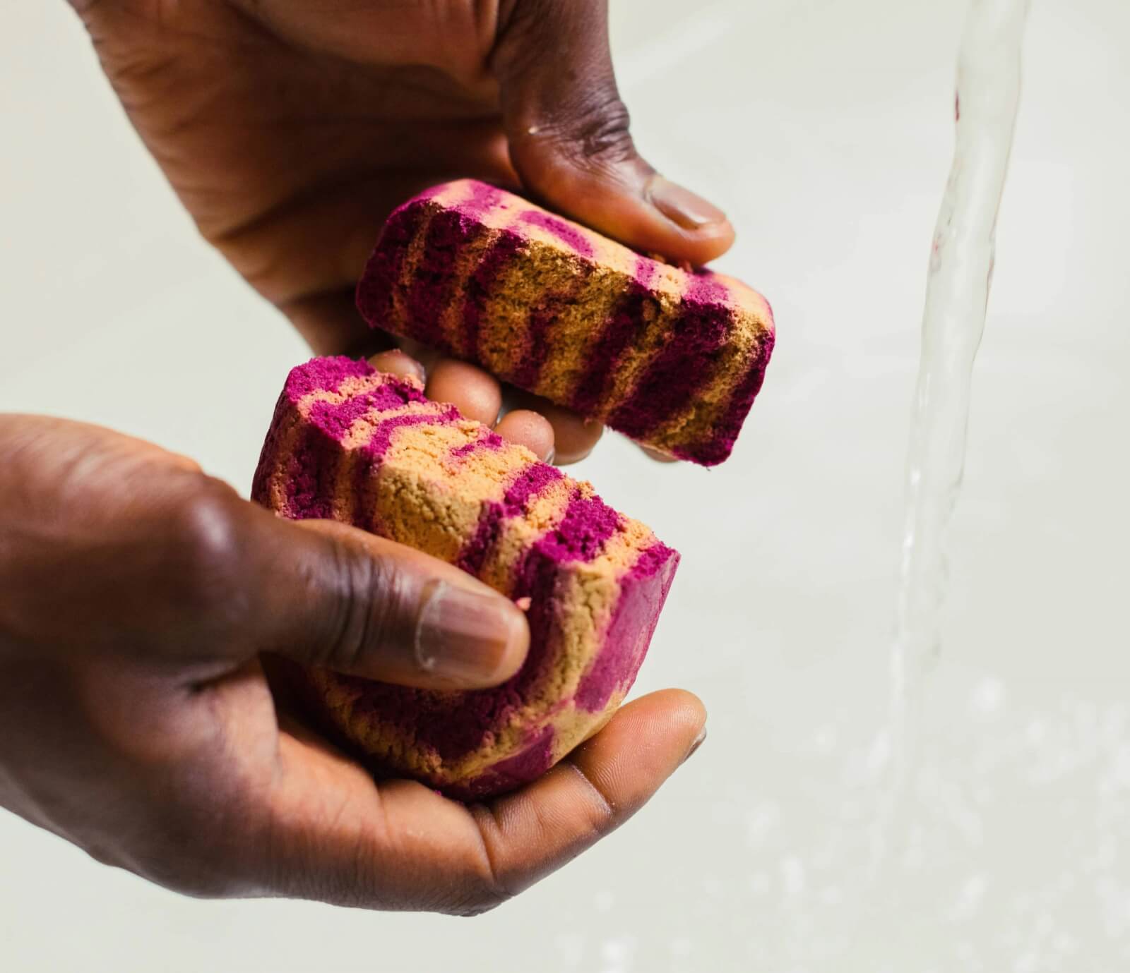 Person breaking cinnamon roll bubble bar