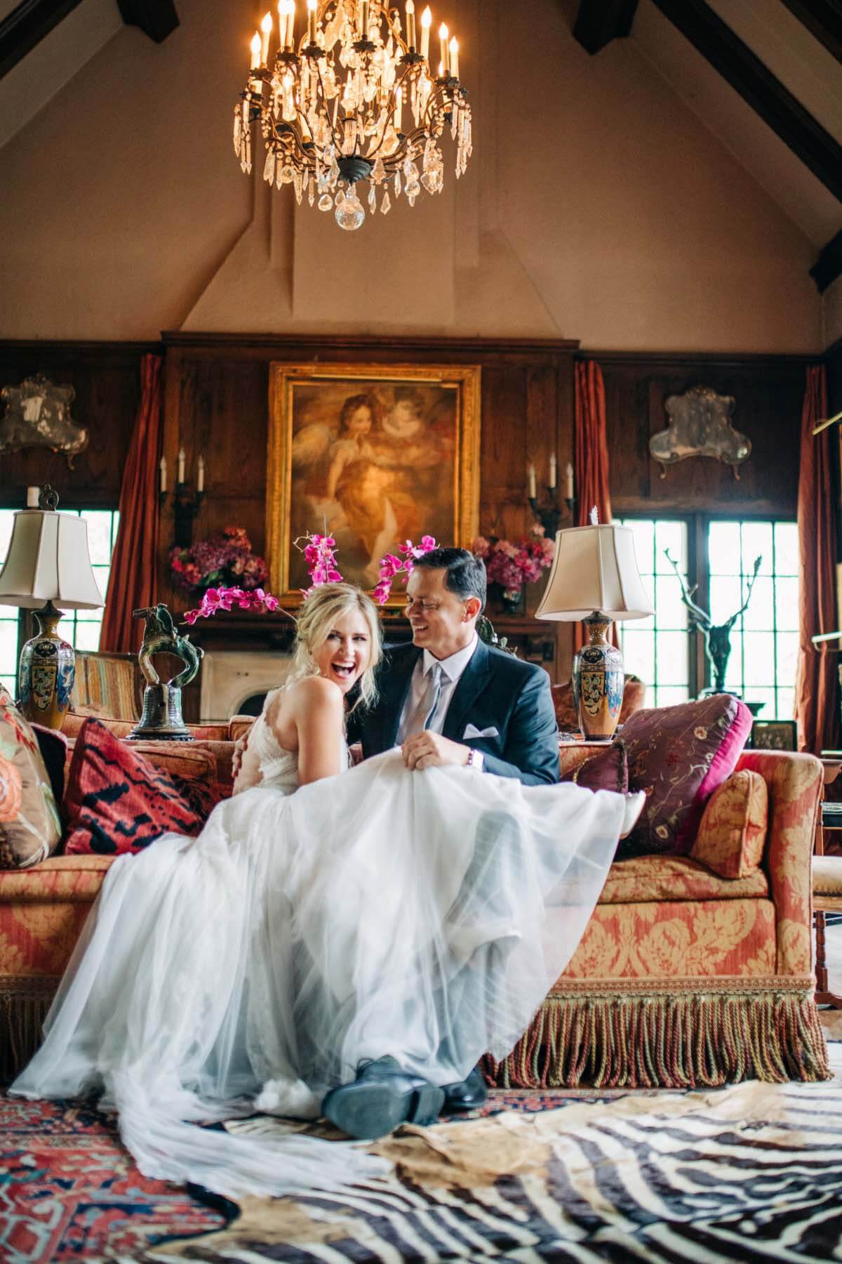 Even before they met in person, Mark and Allison say they were smitten by each other's sense of humor via text. Their wedding day made that obvious, showing just how much the couple loves to laugh together. "Hamming it up and laying out on the sofa and being silly … those turned out to be some of our favorite photos," Allison says. Mark and Allison laugh and ham it up during wedding photos
