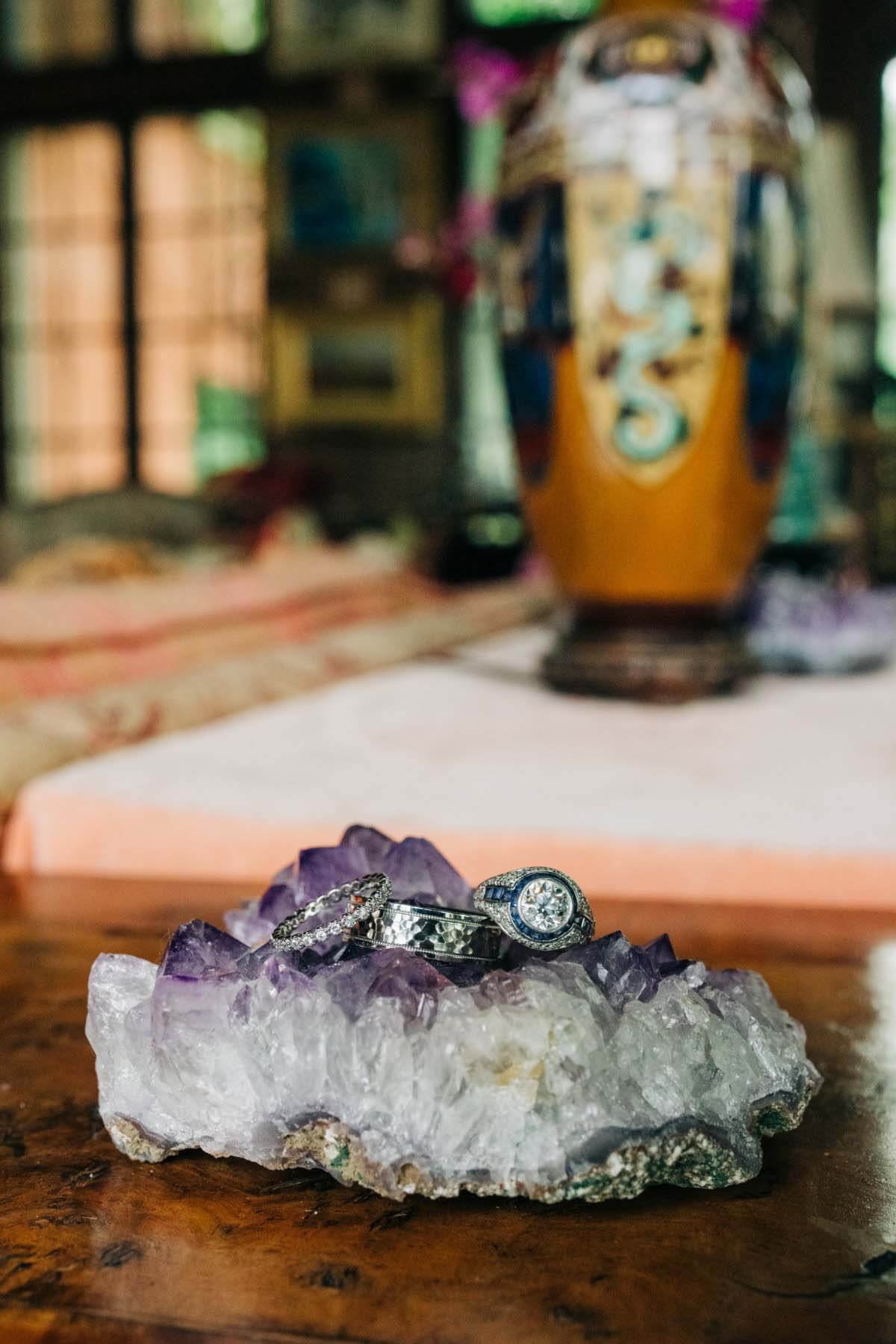 A spur-of-the-moment stop in a Chicago jewelry store led Allison to the perfect wedding ring. Wedding rings resting on amethyst geode
