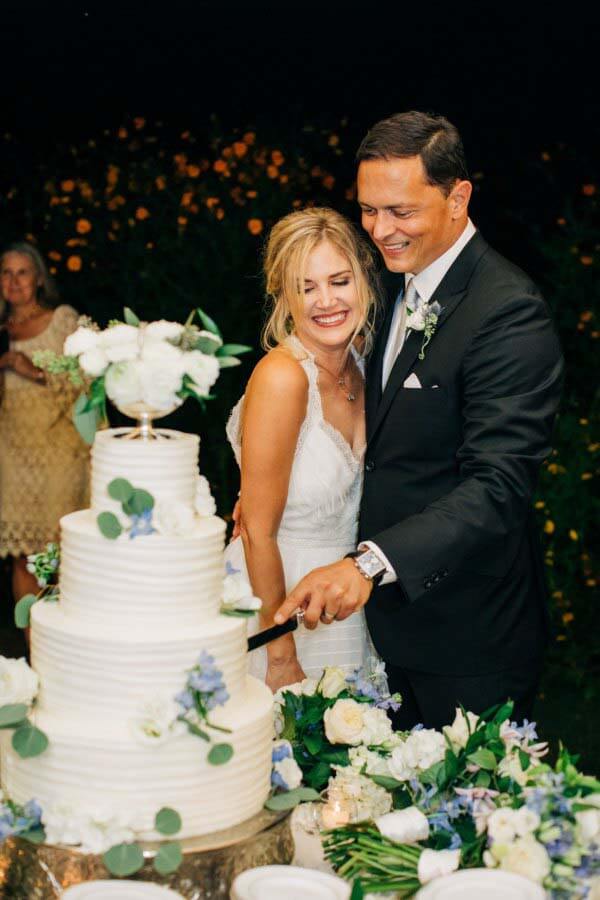 As one might expect, the DJ played "Allison" by Elvis Costello as the newlyweds cut their cake. Allison and Mark, cutting their four-tiered wedding cake in Chickasaw Gardens