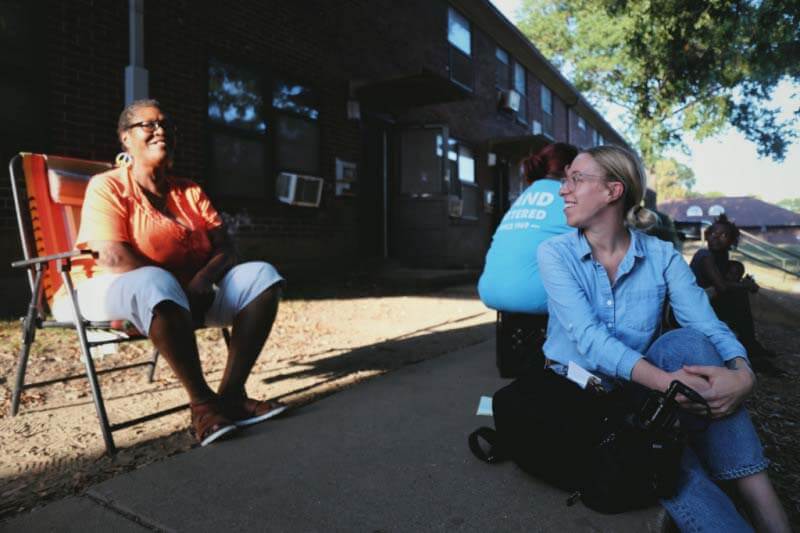 Meribah talking to a resident at the Cayce homes in East Nashville