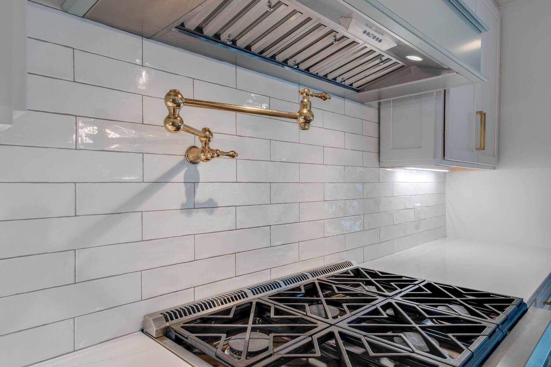 Six-burner stove and pot filler in a Green Hills ranch home renovation