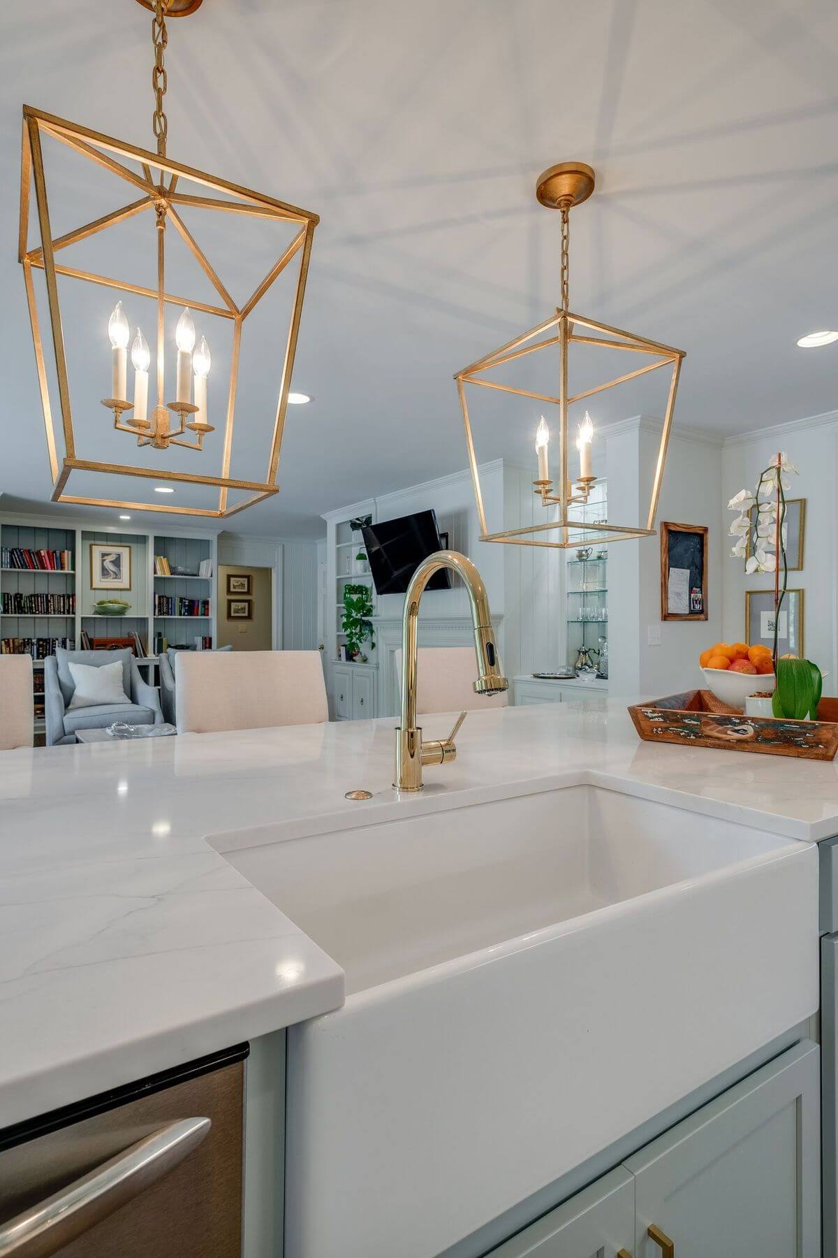 Pendant lights, a quartz countertop and farmhouse sink in Green Hills kitchen