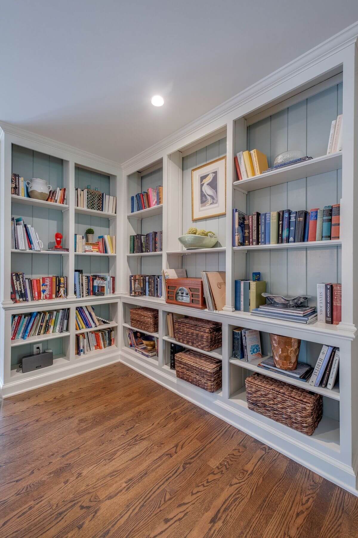 Built-in bookcase with books, baskets and art