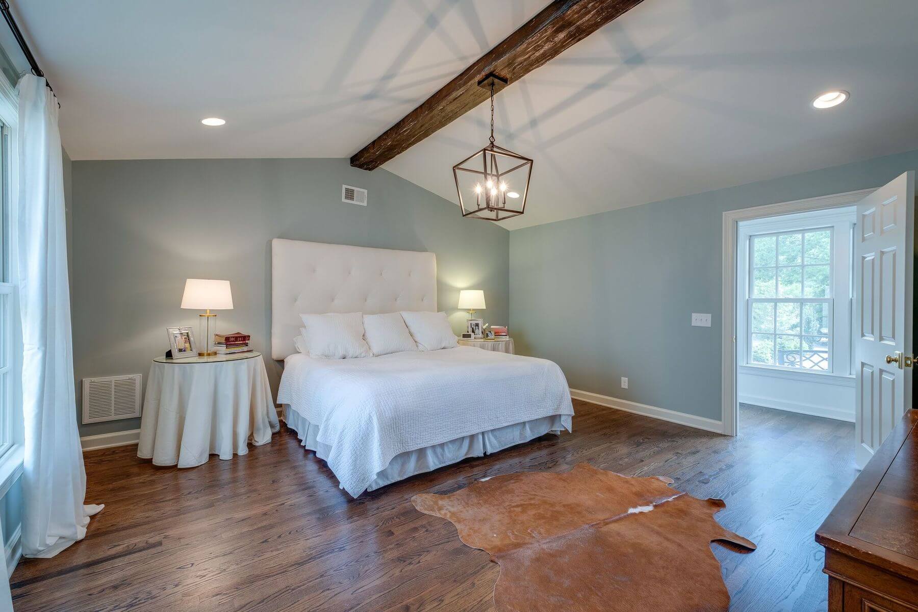 Bedroom with wood beam on ceiling in ranch home renovation