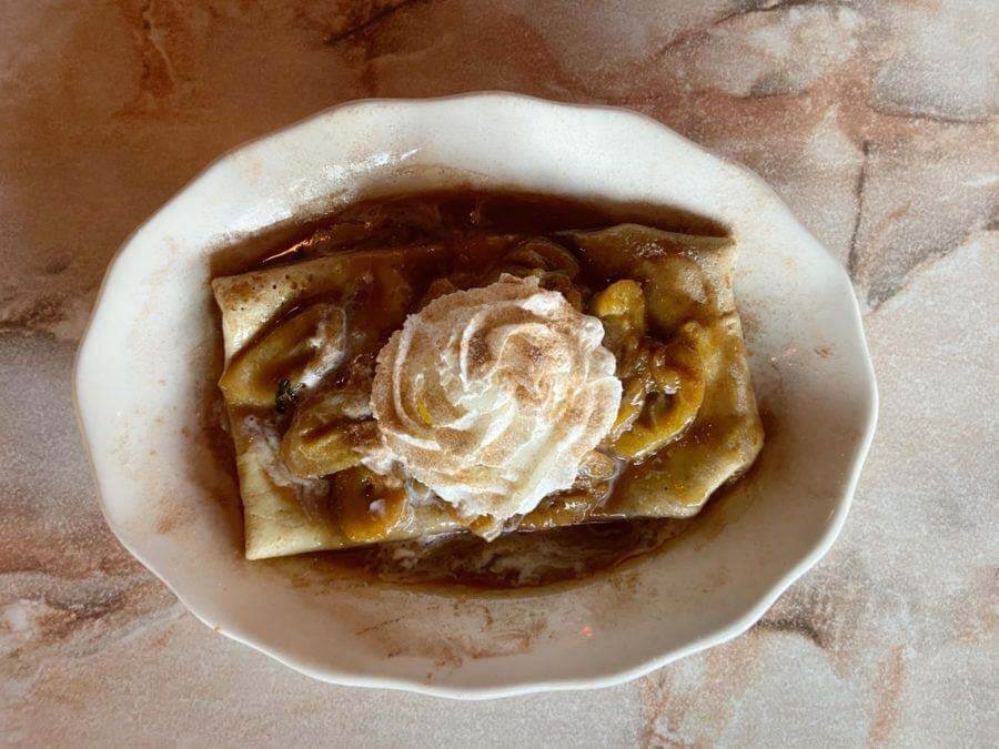 There's nothing like an at-home flambéed dessert to take you from dinnertime to party time! Check out the full recipe below. Image: BRND House New Year's Eve menu dessert: Bananas Foster crêpe