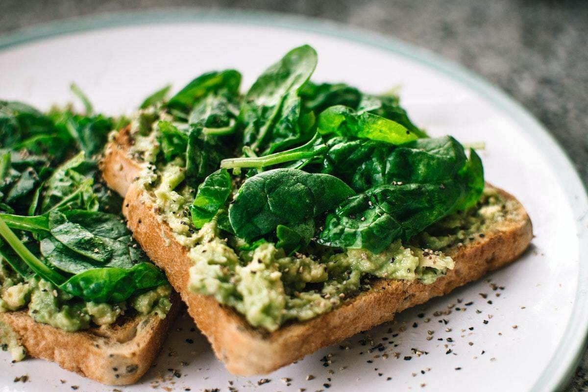 Sustainable, plant-based diets are expected to rise even more this year, as more people pay close attention to the environmental impacts of their food choices and shop locally sourced goods. Toast with avocado spread and spinach