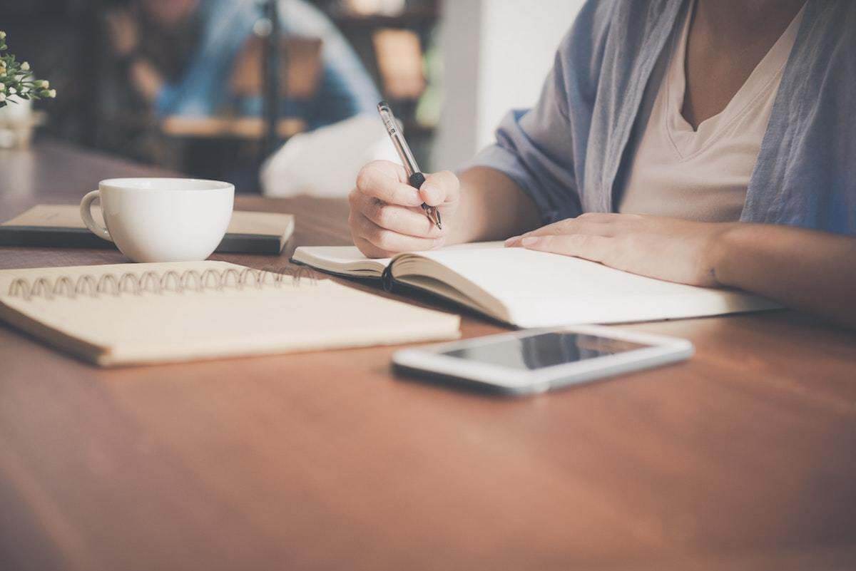 There are two common types of charitable giving: direct and indirect. Each one requires strategic thinking of when, how, and how much to give. Woman writing in notebook