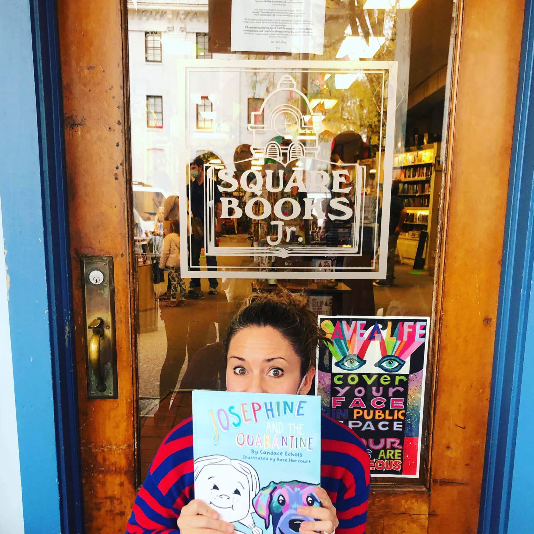 Candace posing with book in front of a local Memphis bookstore