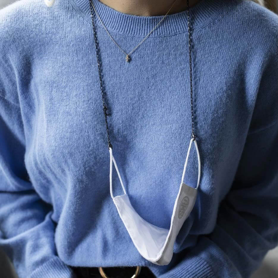 Order Carden Avenue products by December 18 for on-time Christmas delivery. Shop HERE! Protective face mask hanging around neck by black mask chain, a last-minute holiday gift idea