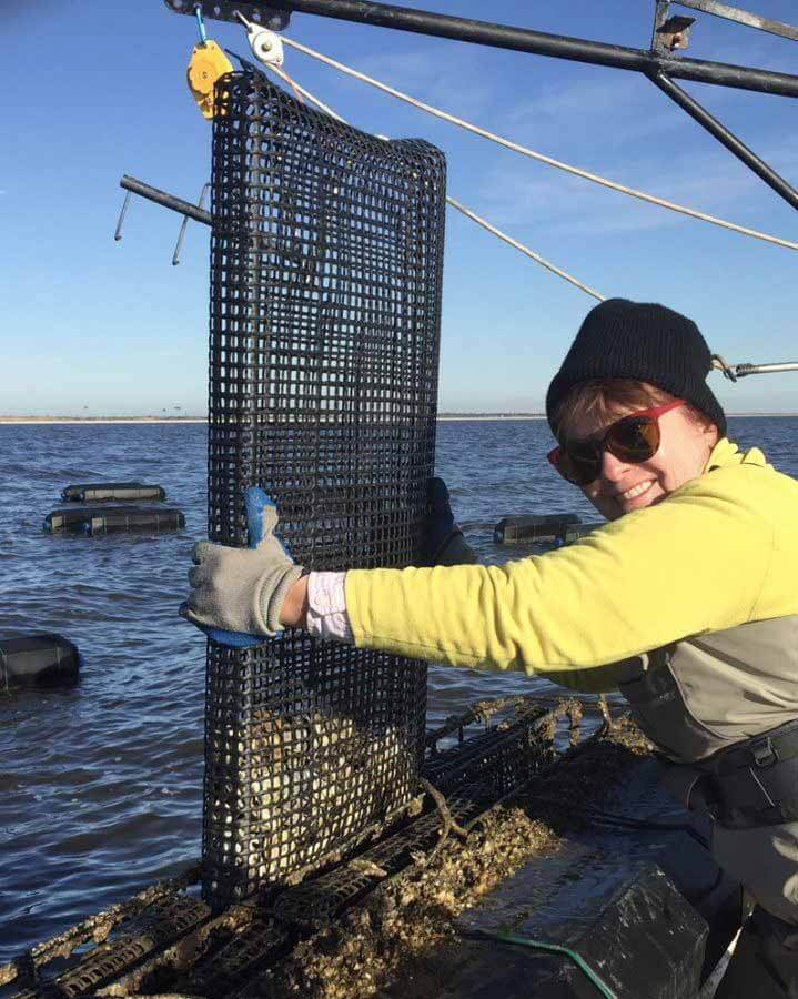 Anita pull up oysters from the Mississippi Sound