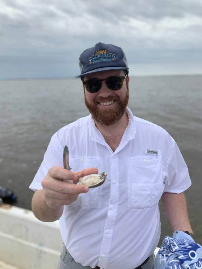 Chef Austin holding a Mississippi oyster