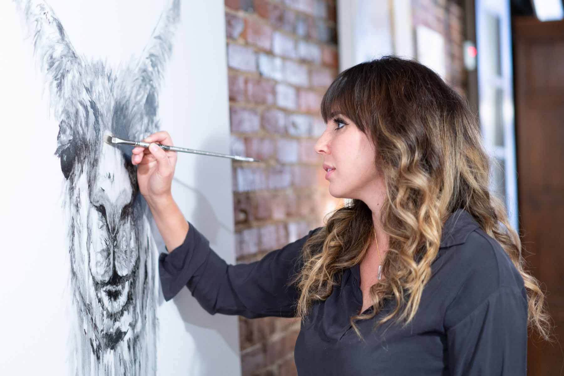 Artist Kristin Llamas painting llama 