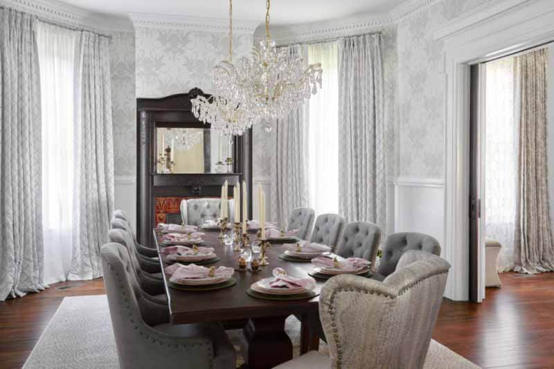 Original fireplace mantel overlooking dining table and chairs