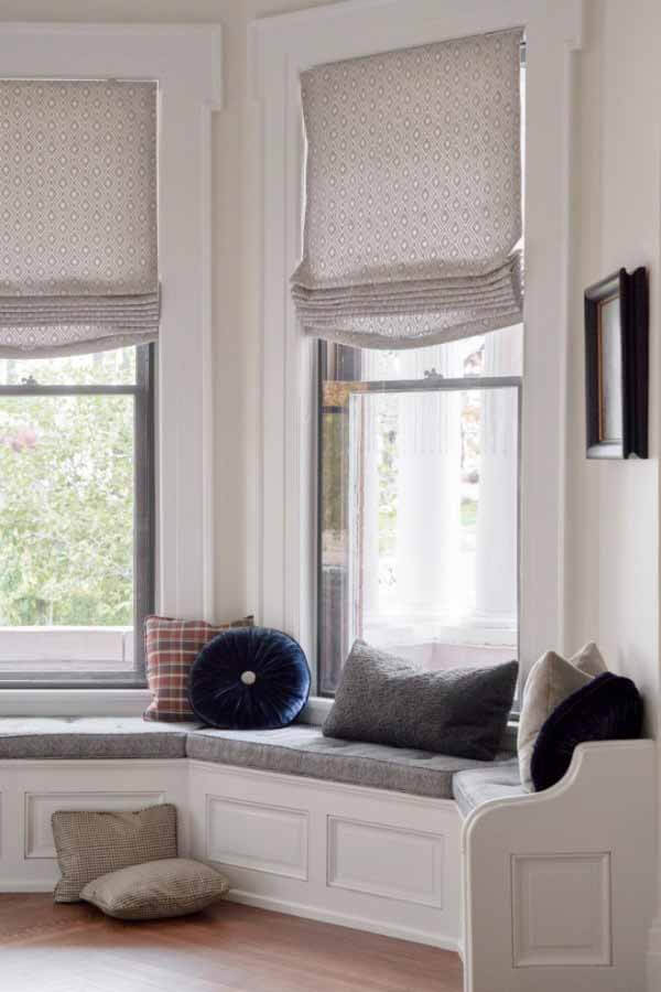 Bay window and built-in bench in the great room of a renovated victorian home