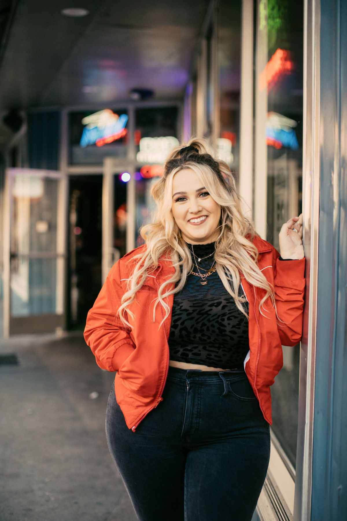 Uncertain what's next on her career path, Priscilla says, "I've really stopped making plans because I had no clue this year would look like this! So, maybe that's the way to go. I think the world needs new music, and I want to get out there, meet the fans, and take this thing to the top." Priscilla Block in red jacket with black top and jeans, smiling