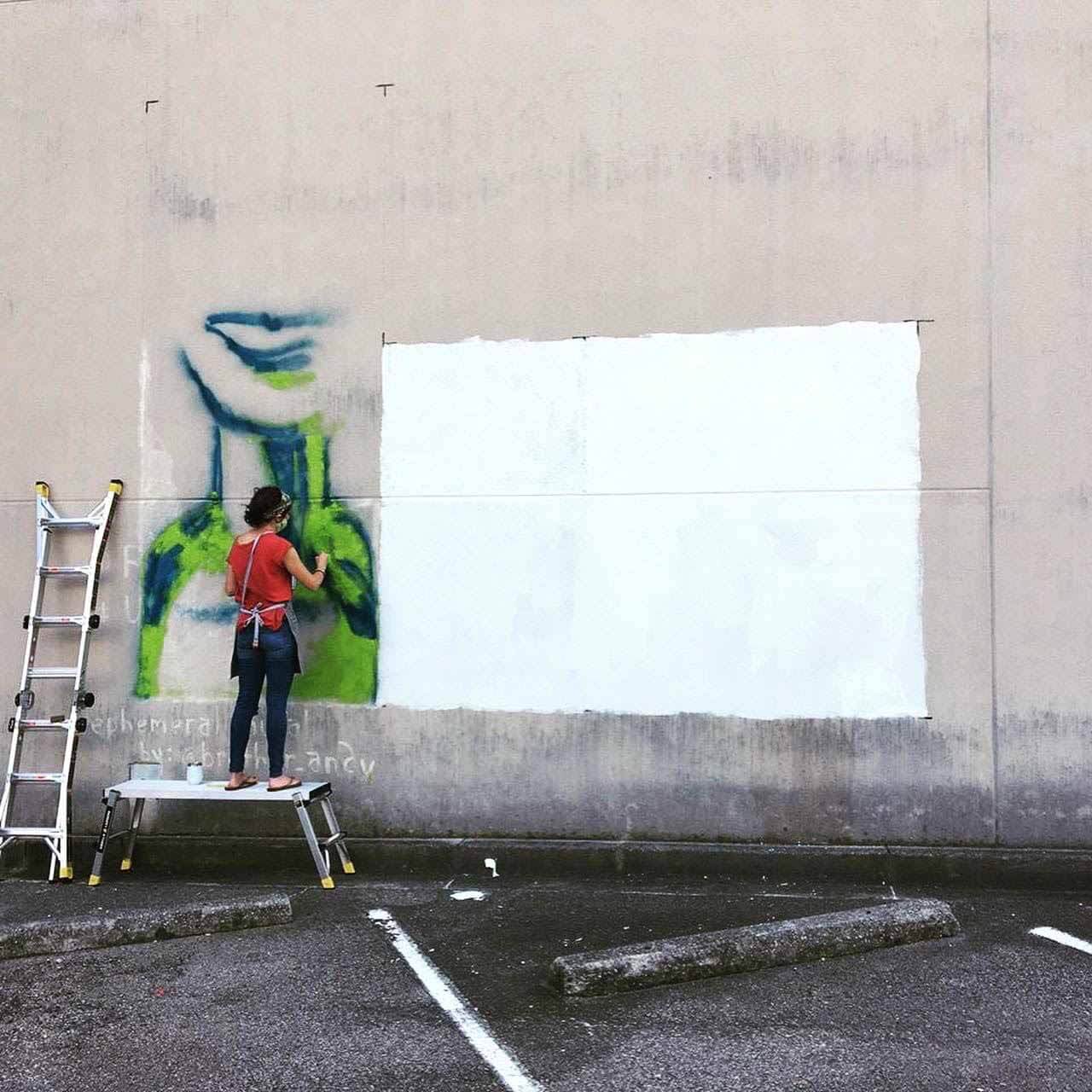 Here, Amanda works on a mural located at 19th Street and 2nd Avenue North, across from The Pizitz. The piece is a collaboration between BHM Artist Collective, REV Birmingham, Blank Space Bham and InSpero. Amanda painting mural on the side of The Pizitz