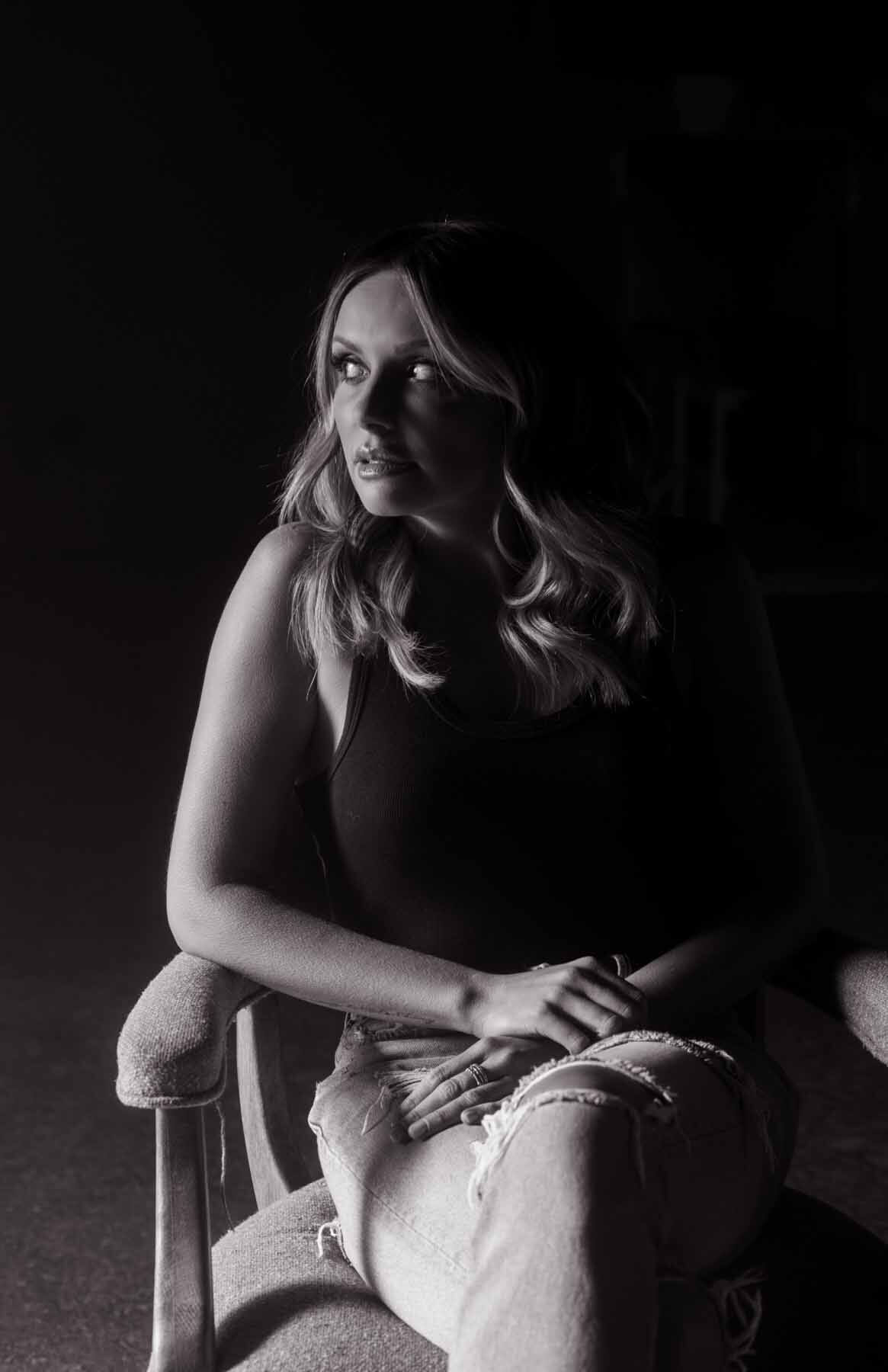 Carly Pearce sitting in a chair, looking off to the side