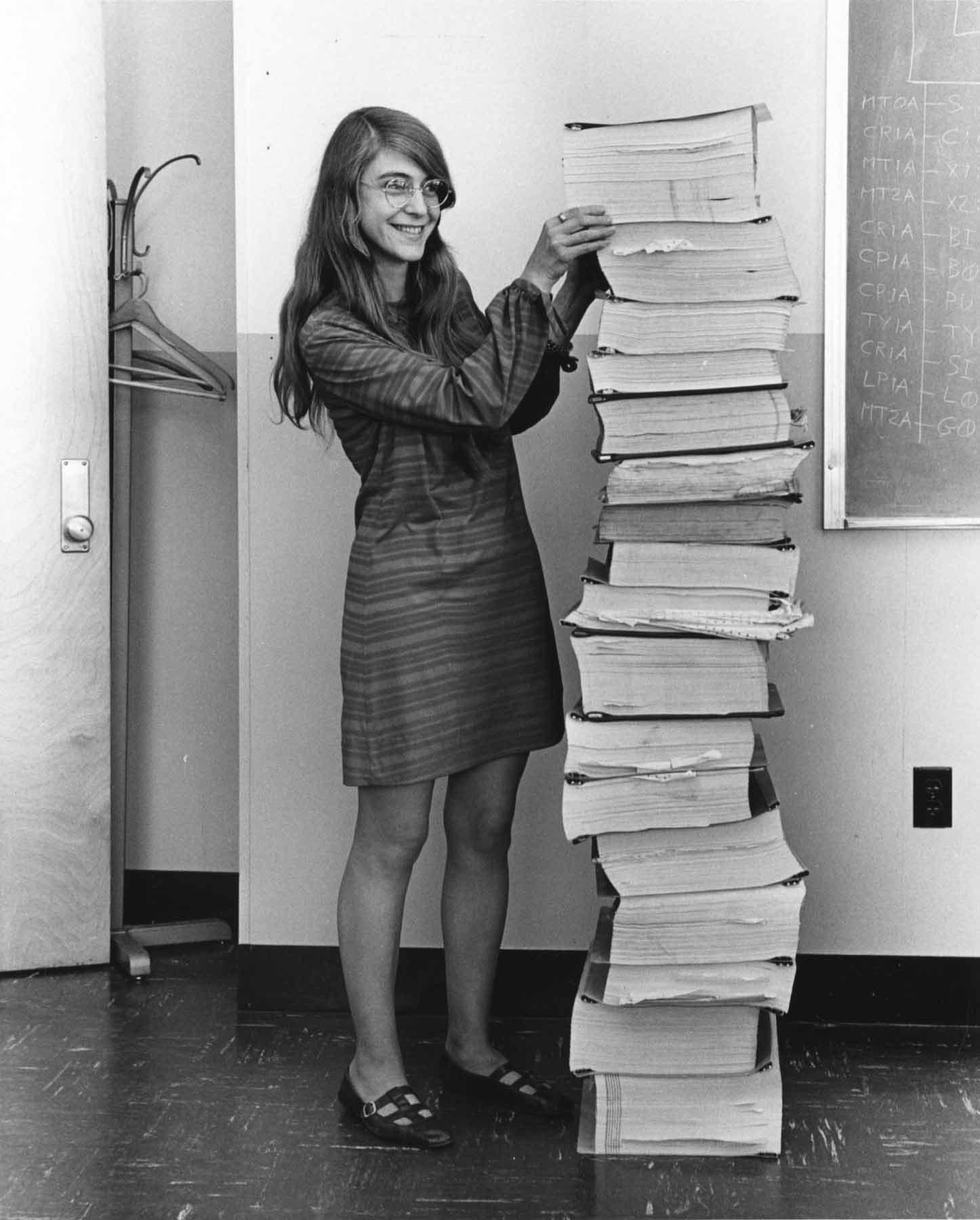 Margaret Hamilton standing by stack of books