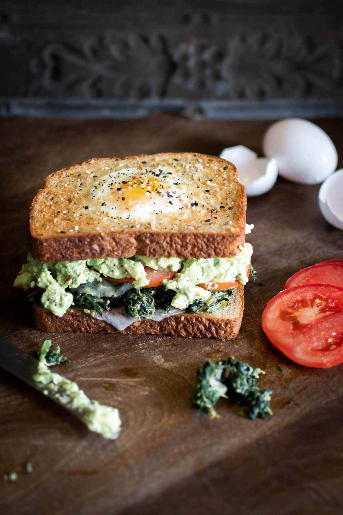The new standard for avocado toasted anything! By the Brewery’s Avocado Toasted sandwich has an “egg in the hole” top layer, served over sautéed spinach, fresh mozzarella, mashed avocado, goat cheese, and tomato. Image: Hannah Joyce Photography By the Brewery’s Avocado Toasted sandwich