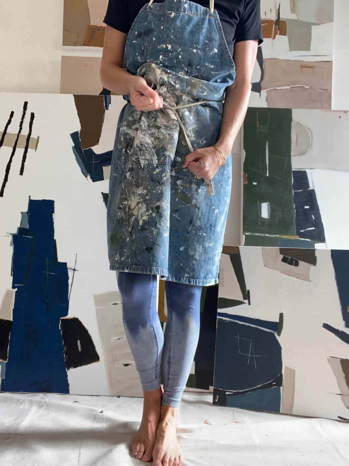 Artist wearing paint-covered smock