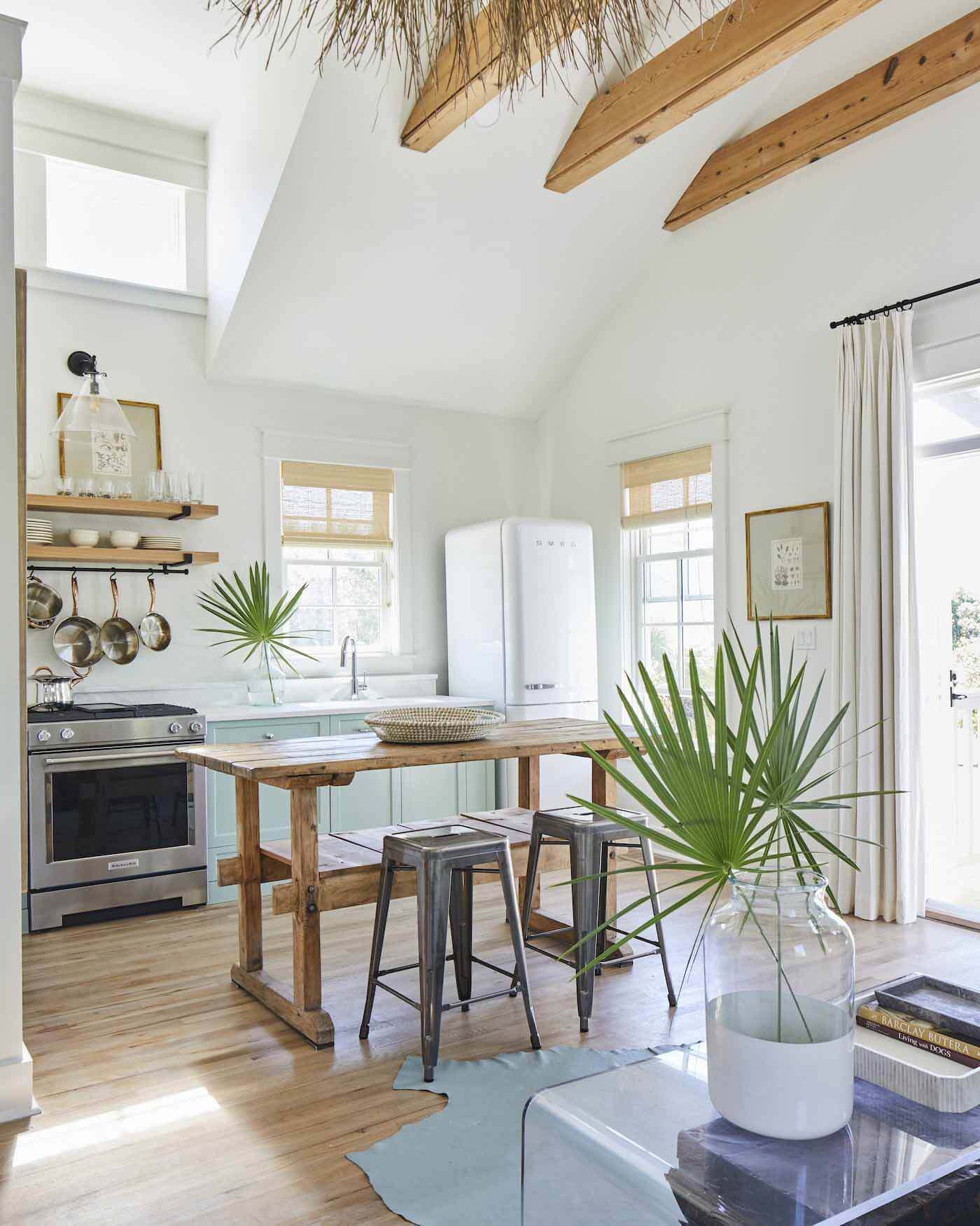 The carriage house above the garage is ideal for guests who enjoy privacy. It is a big, open space that includes a kitchen, bedroom and living area. Kitchen area of carriage house in Florida home