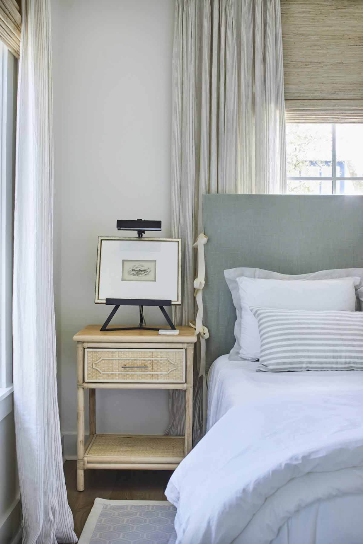The upstairs bedroom's headboard is a tie-on cover that can easily be removed and cleaned; this is yet another durability design detail in the house. Ashley didn't sacrifice functionality and durability for style — instead, the two came together. Beach bedroom with tie-on cover headboard