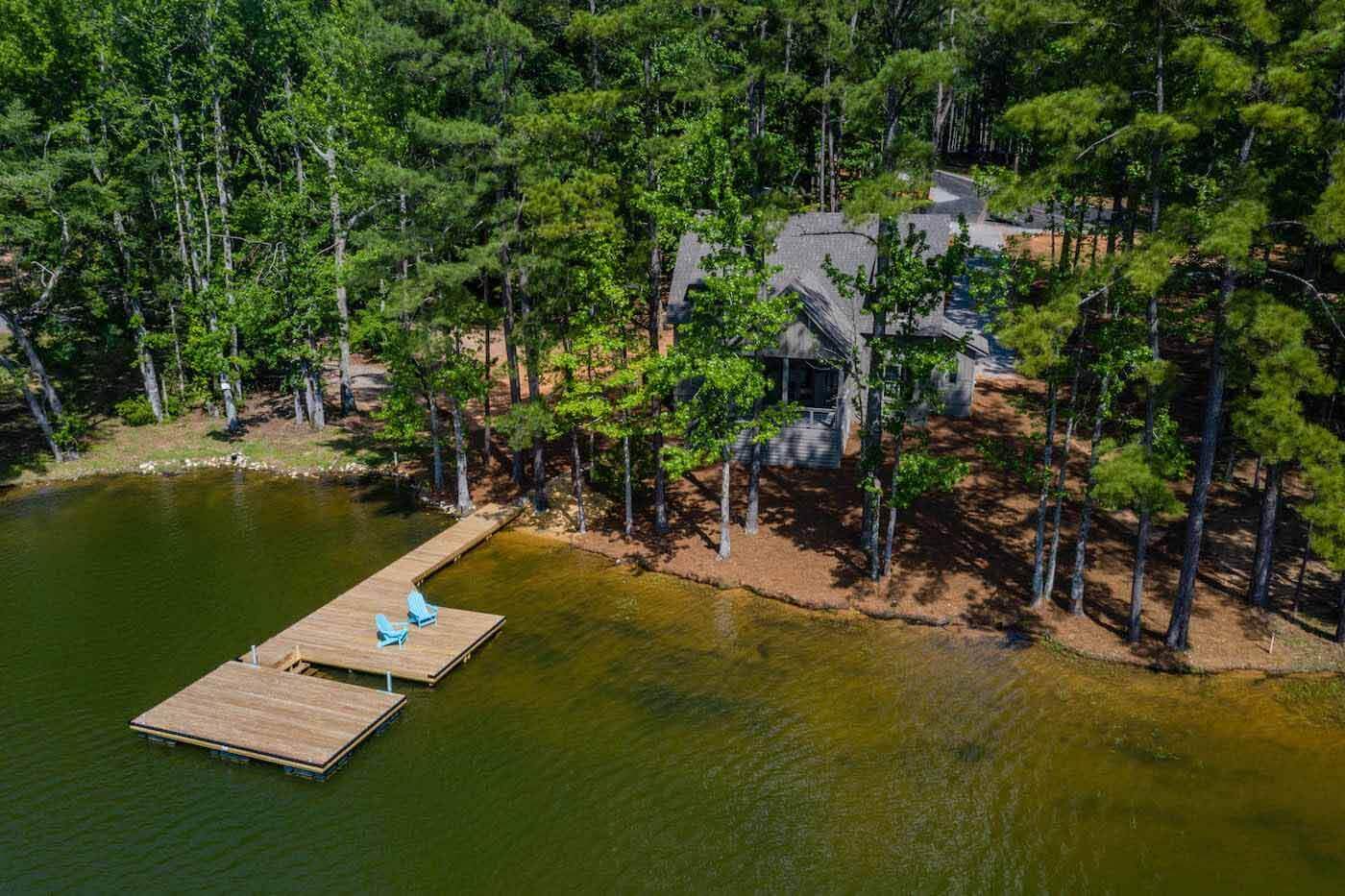 Aerial view of White Oak Landing home surrounded by green trees
