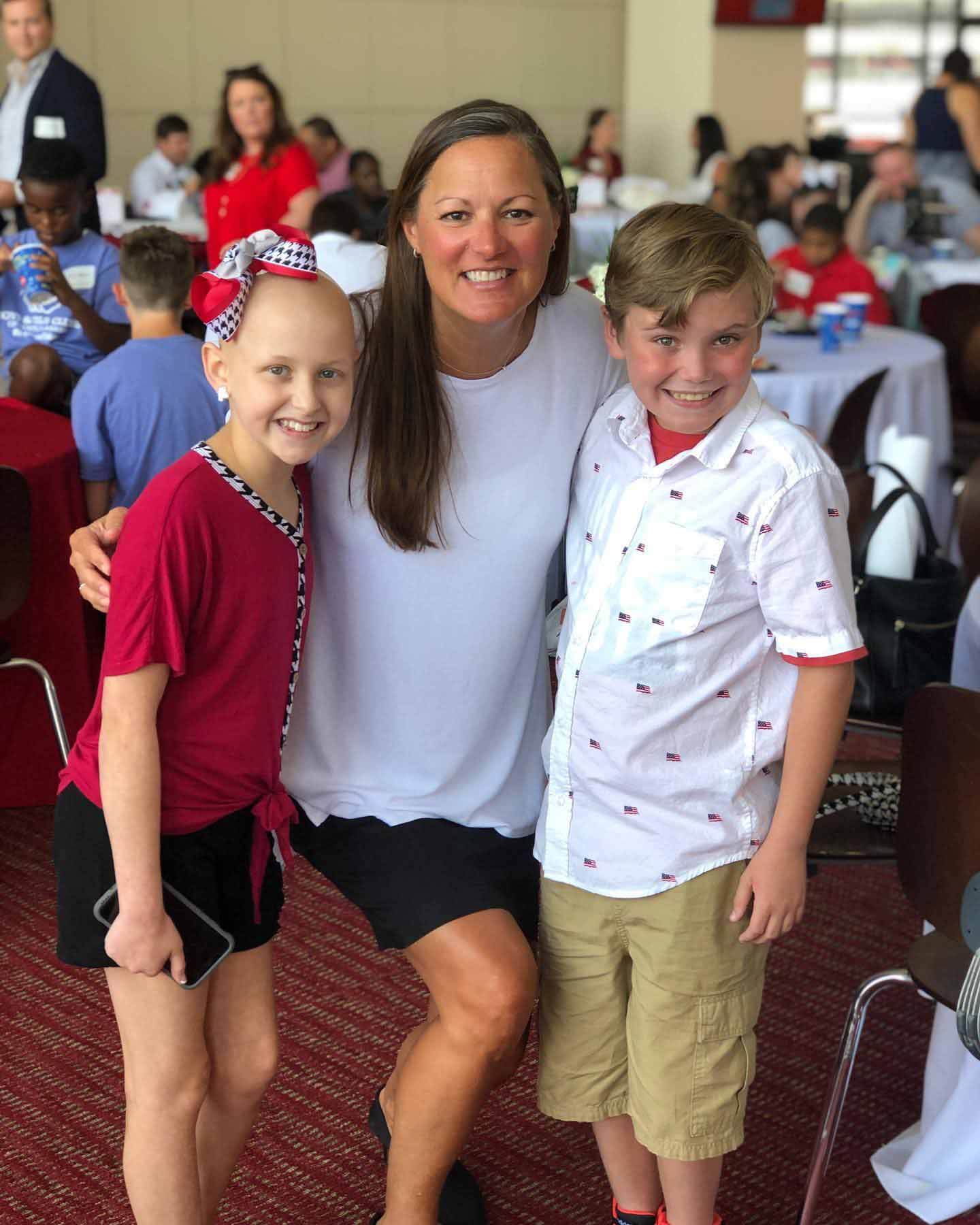 Tracy posing with two children