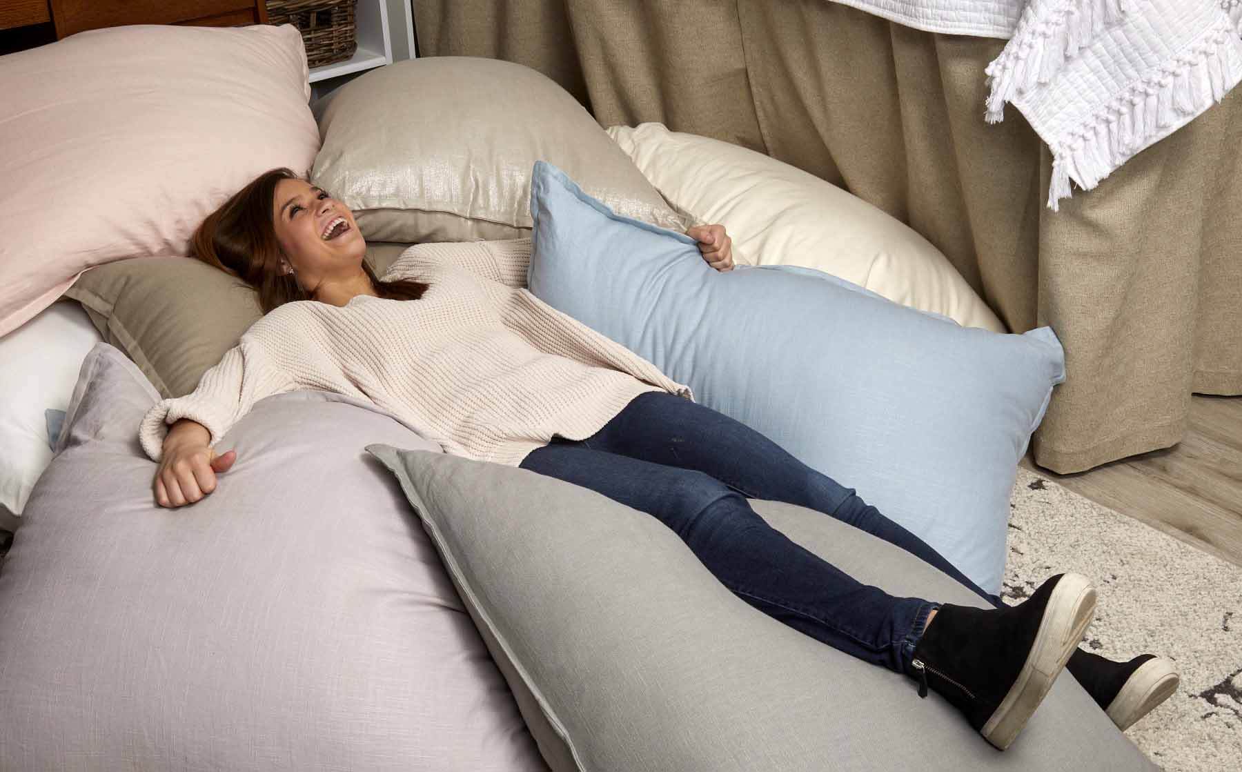 The large Dutch Euro pillows are perfect for support during late-night study sessions or relaxing after a long day of classes. Find them in 16 fabrics HERE for $219. Young girl laying with multiple Dutch Euro pillows