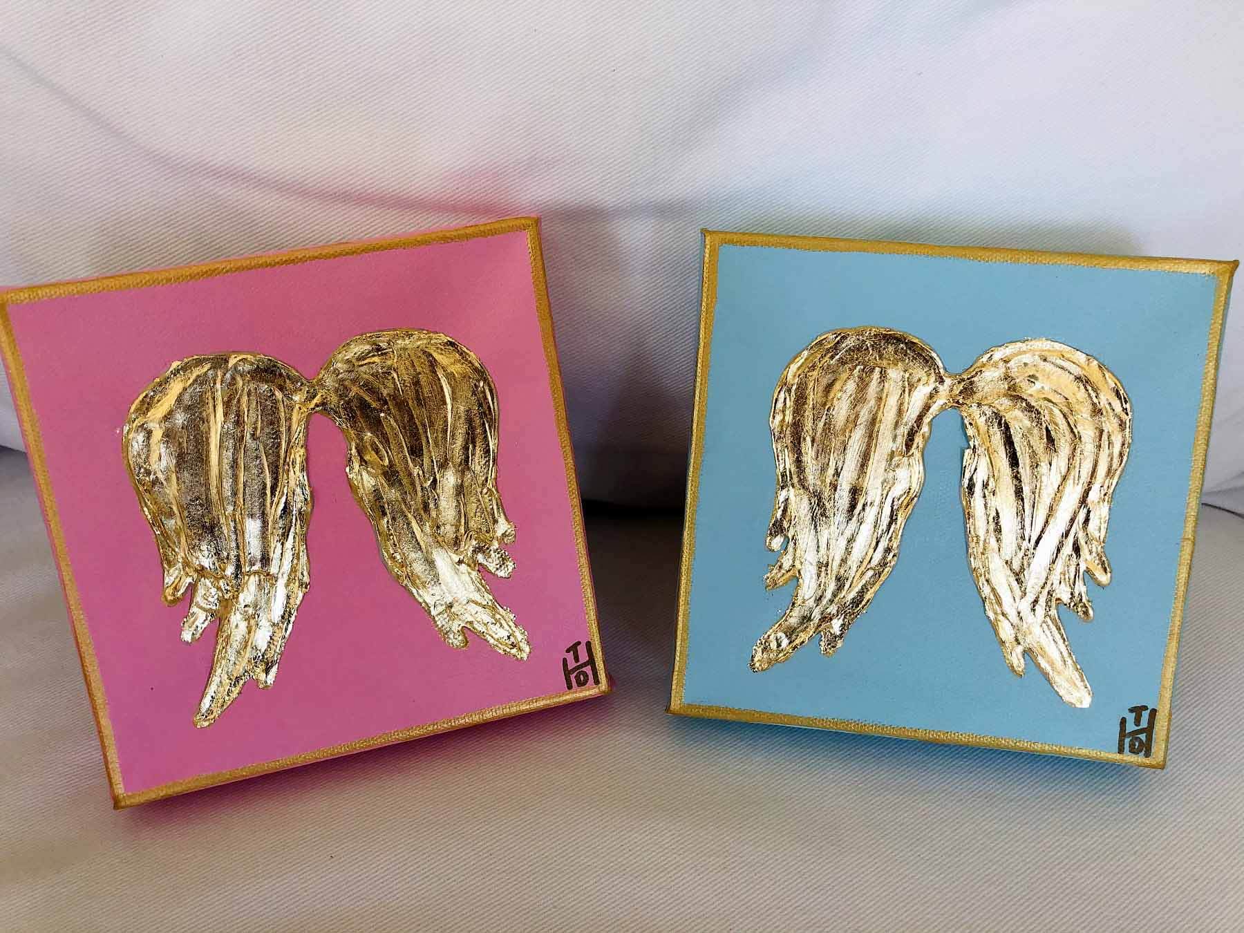 Two small angel wing canvases that Jana Lamanna gives her clients