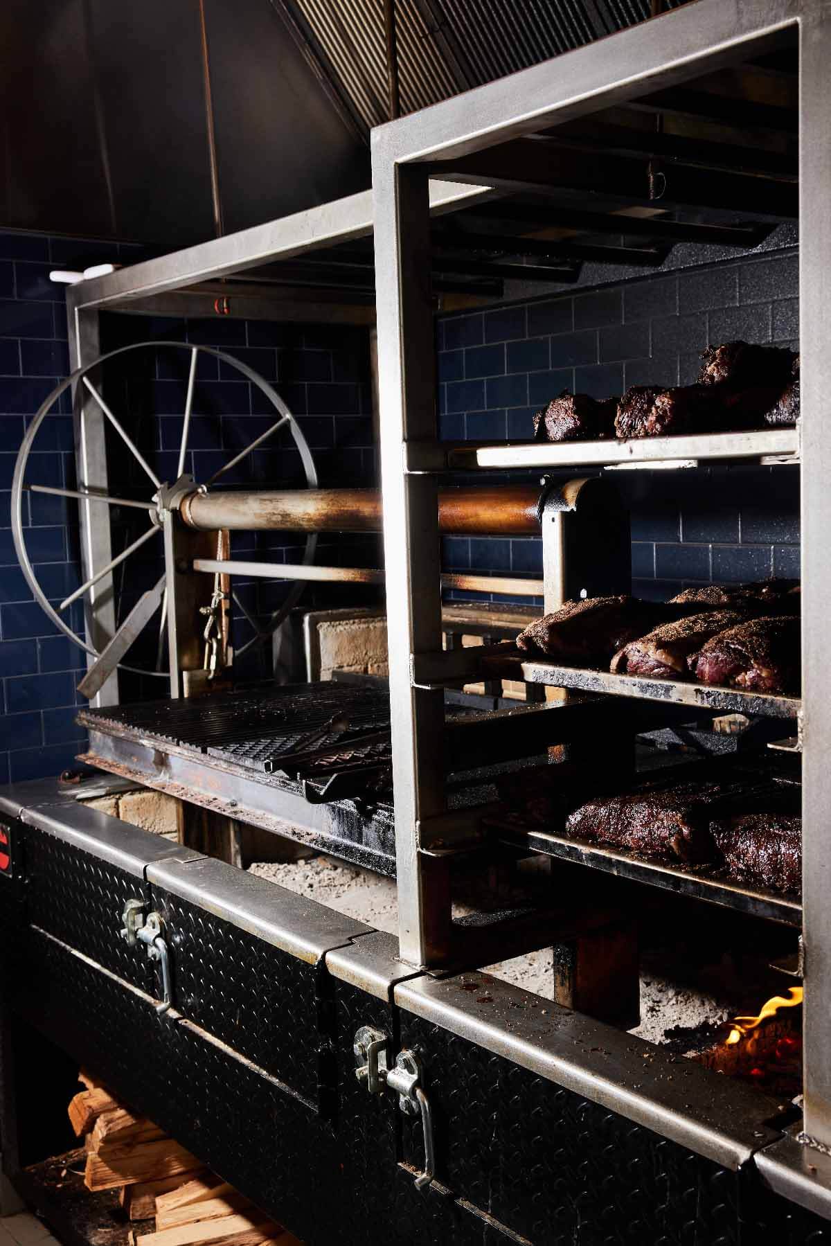 Meats cooked low and slow over an open hearth are highlights of The CItizen's menu. Image: Devote Studios Wood-fired hearth at The Citizen at Alys Beach