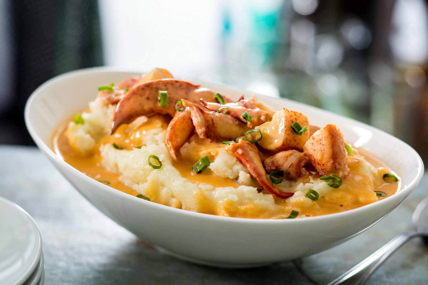 The buttery poached lobster over grits is a fine update of the classic Lowcountry favorite. Image: Eddie V's Prime Seafood Butter poached lobster from Eddie V's