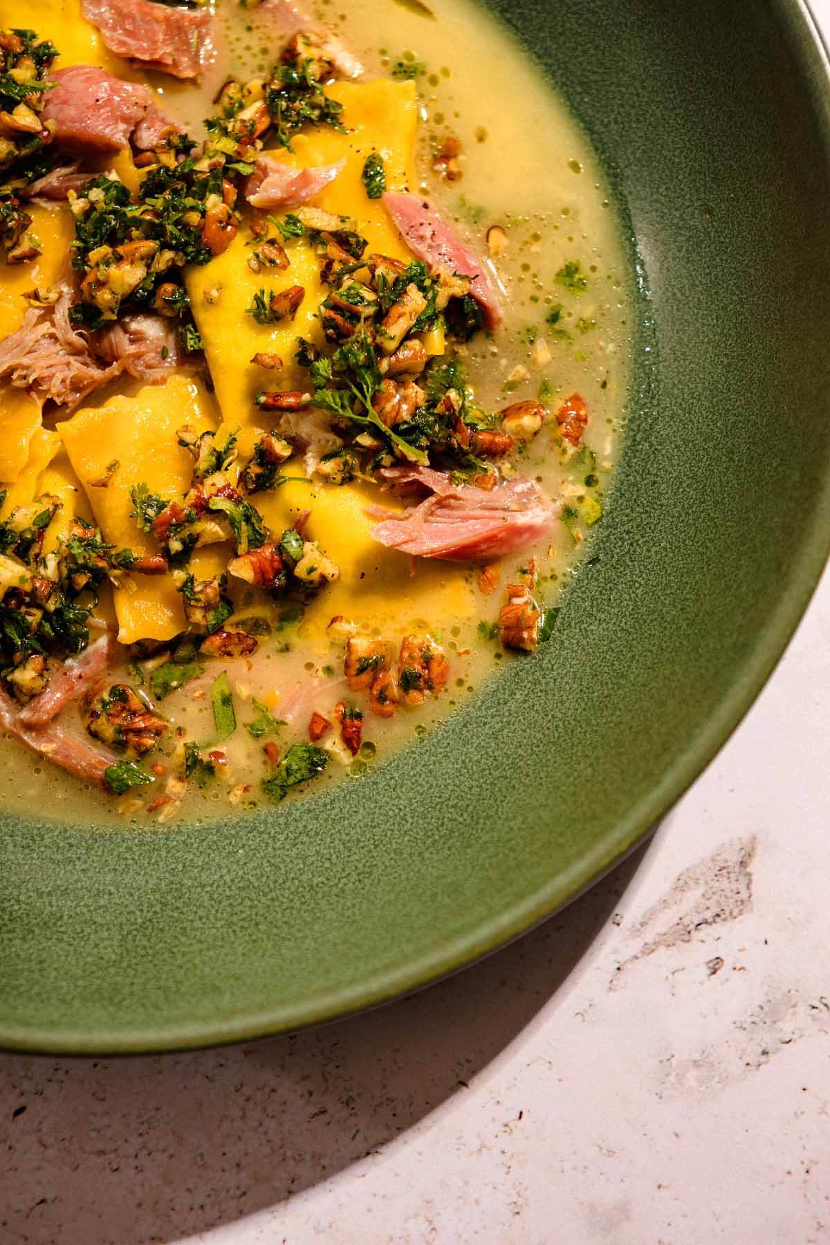 Butter bean agnolotti with ham hock broth is a lovely combination of downhome and international fare. Image: Baxter Miller Agnolotti pasta stuffed with butter beans from Lenoir, a new Southern restaurant