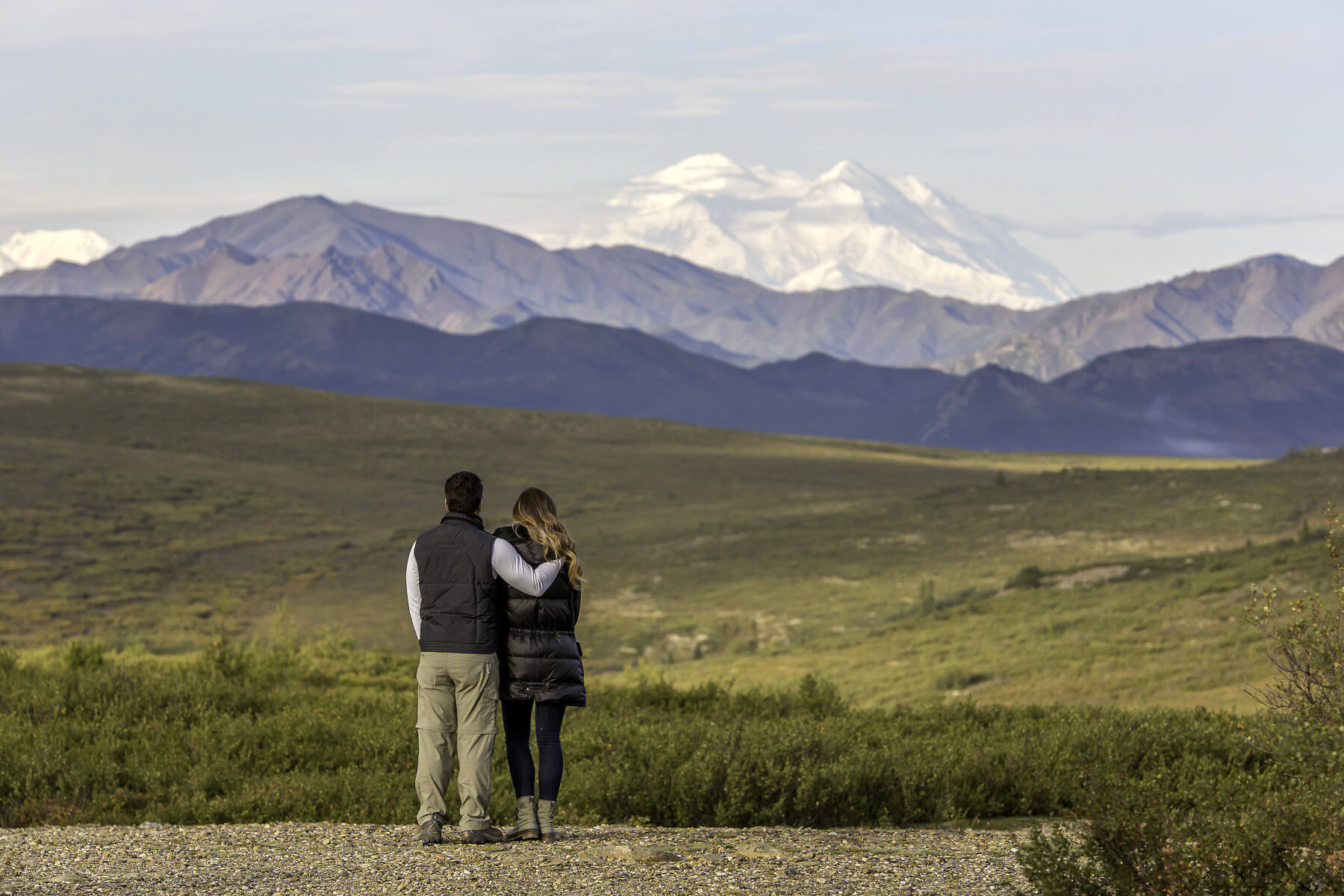 Couple looking out toward a mountain range