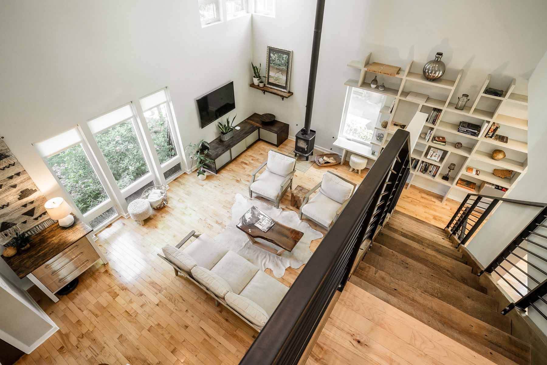 Aerial view of home's living room with tall ceilings