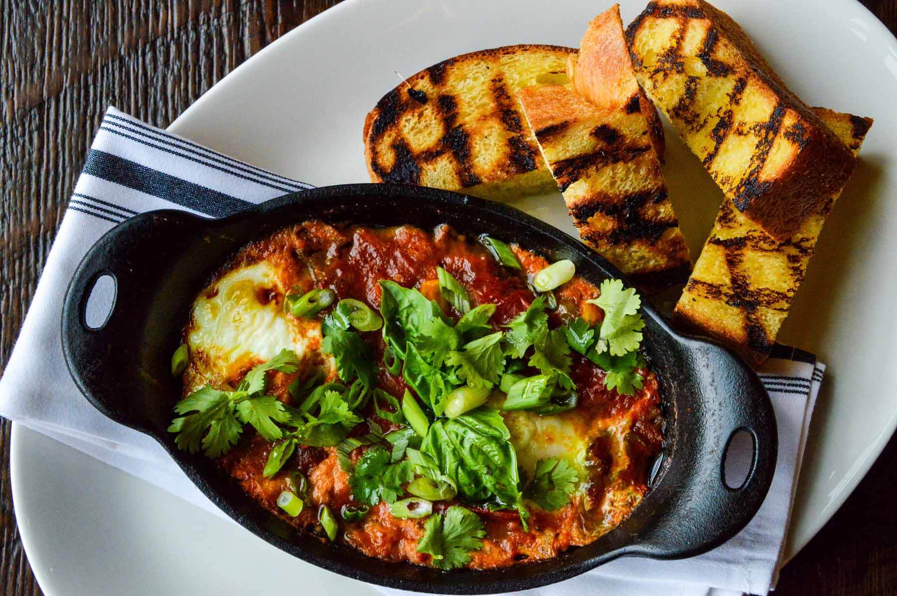 Barn8's Mother's Day brunch menu includes shakshuka — a combination of grilled za’atar focaccia, feta, herbs and Woodland Farm eggs. Image: Barn8 Mother's Day brunch Louisville: shakshuka from Barn8