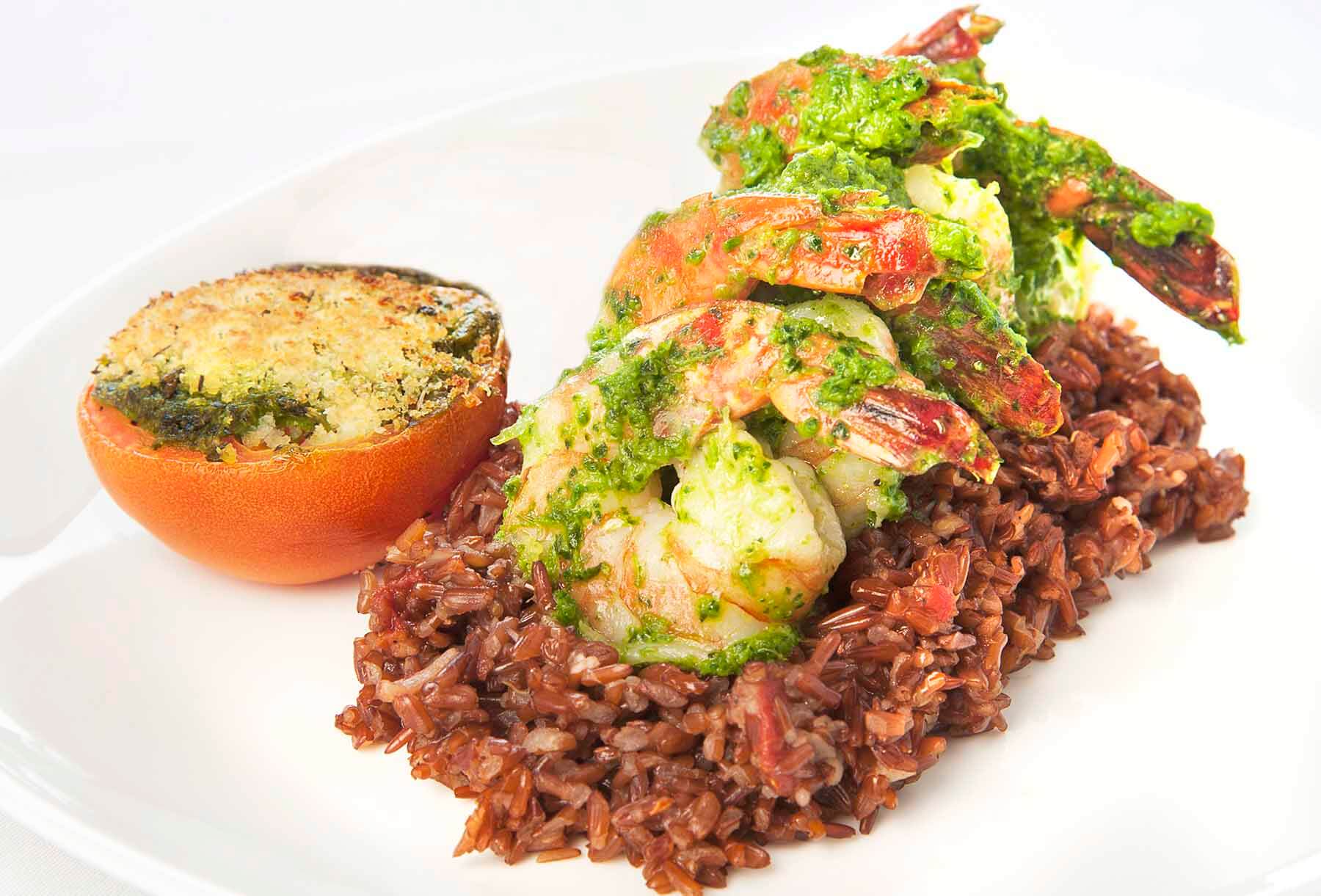 The shrimp persillade from Brasserie Provence includes Camargue rice, provençale tomato, and garlic-parsley butter sauce. Image: Stacy Duncan Shrimp persillade from Brasserie Provence