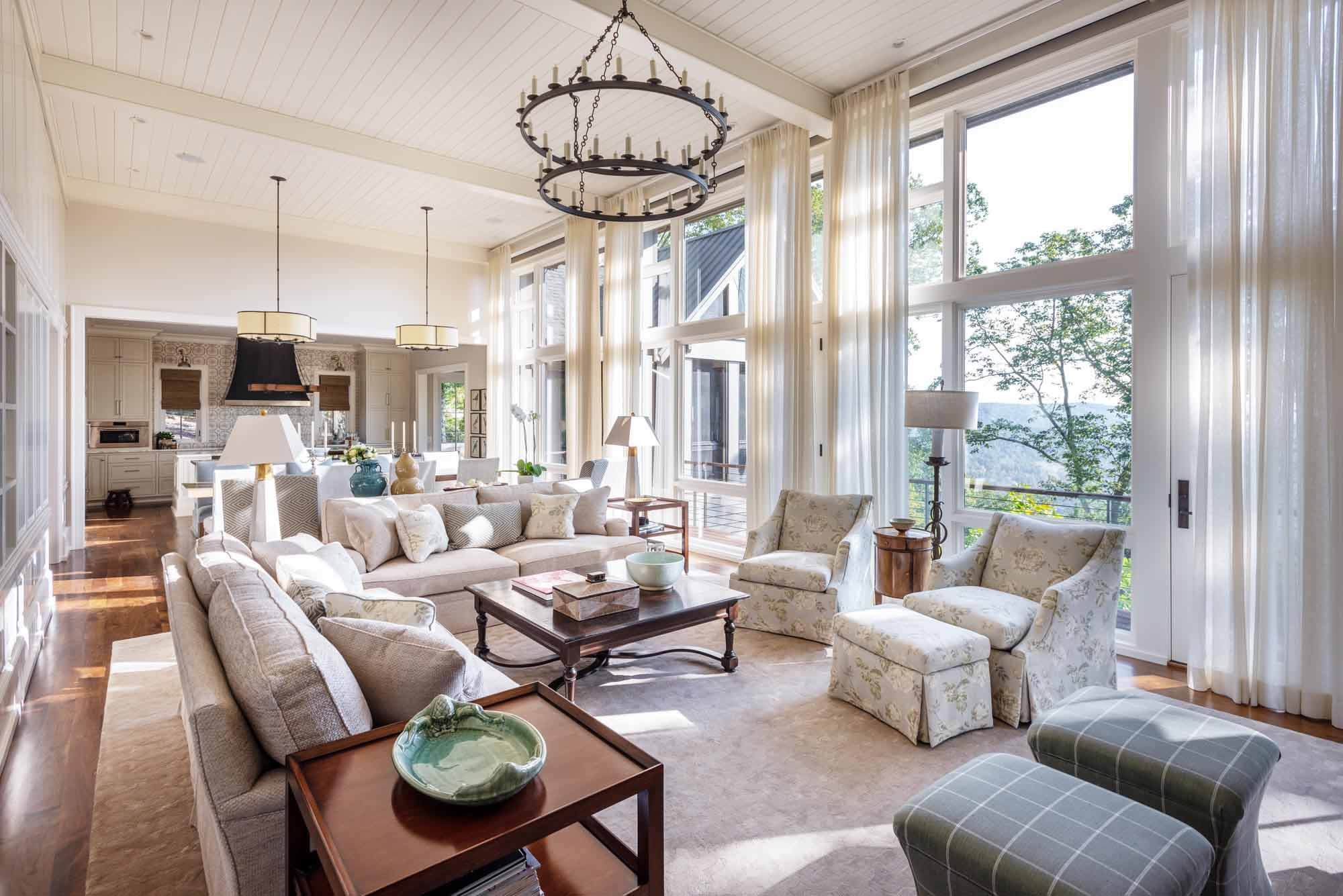A neutral interior color scheme offsets the outdoor greenery that you can see from the massive floor-to-ceiling windows. Image: Reed Brown Photography Interior of a lakeside Sewanee home with a view