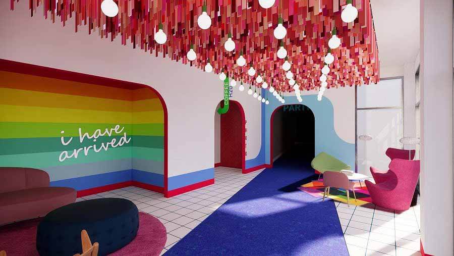 5 Nashville Boutique Hotels to Buy Out for Your Wedding Weekend - 5 A colorful hotel lobby with a sign that reads "I have arrived."